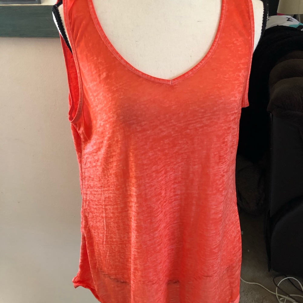 Orange tank with Aztec print skirt.